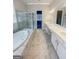 Primary bathroom features marble tile, large soaking tub, a separate shower, and double vanity sinks at 3695 Andover St, Cumming, GA 30028