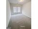 Bedroom with neutral carpet and two windows at 3695 Andover St, Cumming, GA 30028