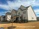 Charming two-story home with white siding, gray stone accents, manicured landscaping, and a welcoming front entrance at 3695 Andover St, Cumming, GA 30028