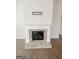 Living room fireplace with a white mantel and brick surround at 3695 Andover St, Cumming, GA 30028