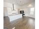Modern kitchen featuring sleek white cabinets, stainless steel appliances, and a central island with a breakfast bar at 3695 Andover St, Cumming, GA 30028