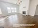 Bright living room featuring hardwood floors, a cozy fireplace, and large windows providing ample natural light at 3695 Andover St, Cumming, GA 30028