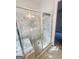 Primary bathroom walk-in shower with marble tile surround, glass enclosure, and shower seat at 3695 Andover St, Cumming, GA 30028