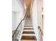 Elegant staircase with wooden steps, white risers, and wrought iron railing leading to upper level at 3695 Andover St, Cumming, GA 30028