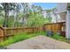Fenced backyard features a patio area with mature trees, offering privacy and outdoor space at 784 Brookside Parc Ln, Avondale Estates, GA 30002