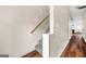Bright hallway with wood floors transitioning to carpeted stairs, leading to other rooms and featuring neutral wall color at 784 Brookside Parc Ln, Avondale Estates, GA 30002