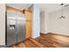 Bright kitchen area featuring stainless steel refrigerator, wood cabinetry, and an open layout into the adjacent living space at 784 Brookside Parc Ln, Avondale Estates, GA 30002