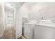 Convenient laundry room with washer, dryer, and shelving for optimal organization and storage at 784 Brookside Parc Ln, Avondale Estates, GA 30002