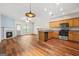 Spacious living area with hardwood floors, fireplace, and an open layout connecting to the kitchen with stainless steel appliances at 784 Brookside Parc Ln, Avondale Estates, GA 30002