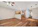Open-concept living area with wood floors, modern ceiling fan, and a view into the kitchen with stainless steel appliances at 784 Brookside Parc Ln, Avondale Estates, GA 30002