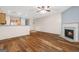 Cozy living room with hardwood floors, fireplace, and adjacent kitchen area with warm-toned cabinetry and ample natural light at 784 Brookside Parc Ln, Avondale Estates, GA 30002