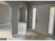 Welcoming entrance featuring gray tiled floors and an arched doorway leading to a living area at 2160 Creekview Trl, Decatur, GA 30035