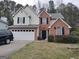 Charming two-story home with a two-car garage, manicured lawn and brick facade at 2160 Creekview Trl, Decatur, GA 30035