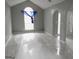 Open-concept living area with sleek tile flooring, neutral paint, and natural light at 2160 Creekview Trl, Decatur, GA 30035