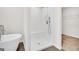 Clean white bathroom features a tiled walk-in shower with bench seat and a soaking tub at 328 Wandering Brook Dr # 39, Mcdonough, GA 30253