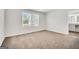 A spacious carpeted bedroom features dual windows and bathroom entrance, offering plenty of natural light at 328 Wandering Brook Dr # 39, Mcdonough, GA 30253