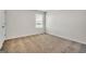 Neutral bedroom features a plush carpet, ample natural light, and a closet for storage at 328 Wandering Brook Dr # 39, Mcdonough, GA 30253