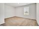 Cozy bedroom with neutral carpet, bright window, and a clean and simple design at 328 Wandering Brook Dr # 39, Mcdonough, GA 30253