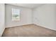 A carpeted bedroom features a window and a door that allows plenty of light to illuminate the space at 328 Wandering Brook Dr # 39, Mcdonough, GA 30253