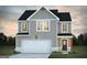 Inviting two-story home featuring a two-car garage and charming exterior lighting at 328 Wandering Brook Dr # 39, Mcdonough, GA 30253
