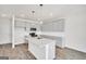 Stylish kitchen featuring gray cabinetry, a granite island, and modern pendant lighting at 328 Wandering Brook Dr # 39, Mcdonough, GA 30253
