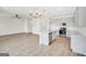 Open kitchen layout with stainless appliances, light gray cabinets, and an island with stone countertops at 328 Wandering Brook Dr # 39, Mcdonough, GA 30253