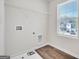 An unfinished laundry room featuring tile flooring and a window providing natural light at 328 Wandering Brook Dr # 39, Mcdonough, GA 30253