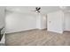 Spacious, open-concept living room with wood-look floors and a ceiling fan at 328 Wandering Brook Dr # 39, Mcdonough, GA 30253