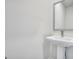 A minimalist powder room features a pedestal sink and a framed mirror, maximizing space at 328 Wandering Brook Dr # 39, Mcdonough, GA 30253