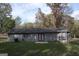 Back view of house with trees, gray siding, and red double doors at 321 Summerwood Ln, Stockbridge, GA 30281