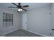 Neutral bedroom featuring a ceiling fan and a window providing natural light at 321 Summerwood Ln, Stockbridge, GA 30281