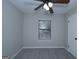 Carpeted bedroom with a window and a ceiling fan at 321 Summerwood Ln, Stockbridge, GA 30281
