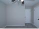 Spacious bedroom with a fan, and two doors in neutral colors at 321 Summerwood Ln, Stockbridge, GA 30281