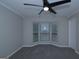 Serene bedroom showcasing a bay window and ceiling fan, offering ample natural light at 321 Summerwood Ln, Stockbridge, GA 30281