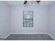 Neutral-colored bedroom with a window, a ceiling fan, and carpet flooring at 321 Summerwood Ln, Stockbridge, GA 30281