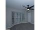 Well-lit bedroom featuring a ceiling fan and bay window, providing a comfortable atmosphere at 321 Summerwood Ln, Stockbridge, GA 30281