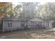Inviting single-story home with neutral siding, red trim, and a well-maintained front yard at 321 Summerwood Ln, Stockbridge, GA 30281
