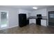 Bright kitchen with white cabinets and black appliances, perfect for cooking and entertaining at 321 Summerwood Ln, Stockbridge, GA 30281