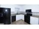 Modern kitchen featuring white cabinets, black appliances, and granite countertops at 321 Summerwood Ln, Stockbridge, GA 30281