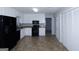 Functional kitchen with white cabinetry, black appliances, and a neutral flooring at 321 Summerwood Ln, Stockbridge, GA 30281
