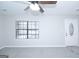 Well-lit room with a neutral palette, featuring a ceiling fan and a window with bright daylight at 321 Summerwood Ln, Stockbridge, GA 30281