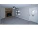 Bright living room featuring a cozy stone fireplace and neutral walls and plush carpeting at 321 Summerwood Ln, Stockbridge, GA 30281