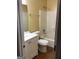 Full bathroom with white vanity, toilet, and shower/tub combo with updated fixtures and tile flooring at 5734 Wellborn Oaks Ct, Lithonia, GA 30058