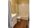 Well-lit bathroom with a white vanity, toilet, and shower/tub combo, complete with neutral tile floors at 5734 Wellborn Oaks Ct, Lithonia, GA 30058