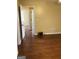 Neutral bedroom showcasing hardwood flooring and multiple entryways to other rooms in the home at 5734 Wellborn Oaks Ct, Lithonia, GA 30058