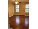Bright bedroom with hardwood floors, two windows providing natural light, and a ceiling fan at 5734 Wellborn Oaks Ct, Lithonia, GA 30058