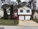 Charming two-story home with brick accents, two-car garage, and manicured landscaping at 5734 Wellborn Oaks Ct, Lithonia, GA 30058