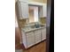 Close-up of the kitchen with stainless steel sink and view into adjacent living spaces at 5734 Wellborn Oaks Ct, Lithonia, GA 30058