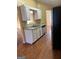 Functional kitchen with white cabinets and granite countertops, adjoining the living area at 5734 Wellborn Oaks Ct, Lithonia, GA 30058