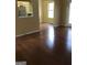 Spacious living room with hardwood floors and a view into the kitchen area at 5734 Wellborn Oaks Ct, Lithonia, GA 30058